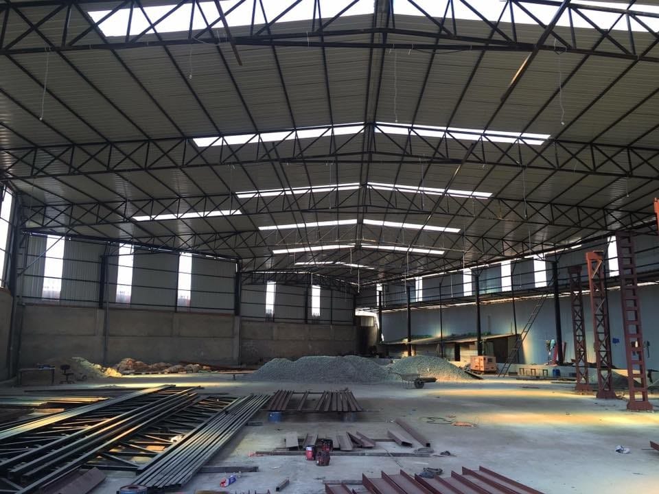 Large warehouse interior with steel truss roof